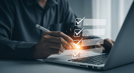 Person using stylus on laptop with digital checklist overlay for task management and productivity