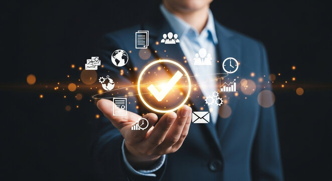 A person in a suit holding a glowing checkmark surrounded by business related icons in their hand