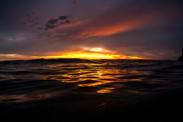 Golden sunset over the ocean as seen from the surface off Sydney, Australia.