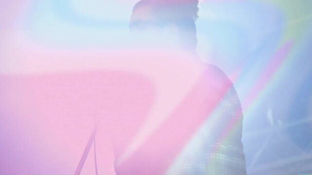 Singer adjusting microphone grip and singing opening music verse while pastel stage lights sweeping