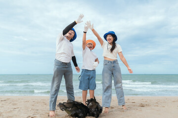 Volunteers clean beach while enjoying community service on a sunny day by the ocean