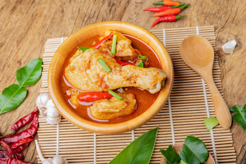 Chicken curry Asian food masala. Traditional cooking healthy food with spices. Arranged on wooden table background.