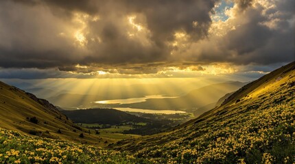 Sunbeams pierce clouds over valley