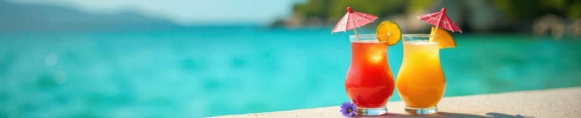 Two exotic fruit drinks with tiny umbrellas near the water's edge,  sun,  tropical