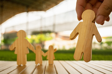 A family symbol showing a father, mother, and child, with a mysterious hand pulling the father...
