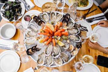 A delectable seafood platter featuring an array of fresh oysters, shrimp, and mussels, perfect for...
