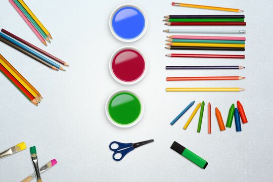 Flat design is showing top-down art workspace with white paint bowls and craft tools