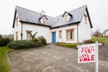 House exterior with real estate signboard