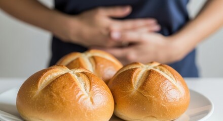 Person with stomach ache after eating bread rolls