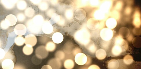 Abstract bokeh lights are being shown in flat style on textured backdrop, with warm golden circles