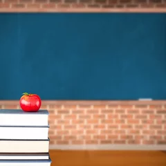 Fototapete Red apple on pile of books in classroom © vectorfusionart