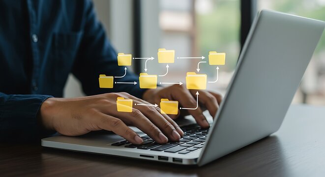 Person using laptop managing workflow through digital file folder organization system
