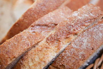 Freshly baked bread slices displayed on a wooden table