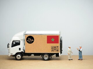 Mini toy of action figure and truck car at table with blurred background. Diorama photography...