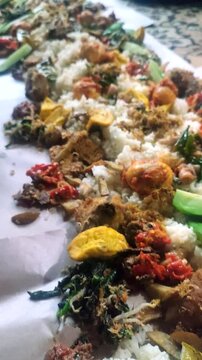 Close-up of "Nasi Liwet" which is one of Indonesia's traditional foods. Usually served on banana leaves with various side dishes and vegetables also served with spicy chili sauce.