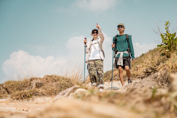 Asian couple hiking mountain trail. Hiker lifestyles activity. Hike trekking backpacker. Backpacker trekking outdoors.