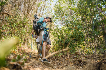 Asian couple hiking forest trail. Hiker lifestyles activity. Hike trekking backpacker. Backpacker trekking outdoors.