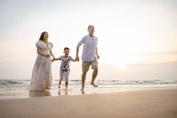 Family holiday vacation beach. Asian happy family outdoors summer travel. Fun families outdoors. Family vacation beach.
