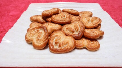 Tasty Heart shaped sweet biscuits with caramel design. Little hearts brand biscuits