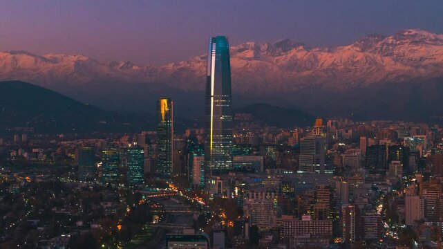 Aerial hyperlapse fly Providencia Neighborhood in Santiago de Chile, South american capital, traffic with trail lights in motion and skyscraper background