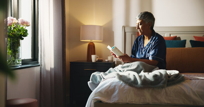 Reading, relax and book with old woman in bed for knowledge, literature self help study. Mindfulness novel, learning and retirement with senior person in bedroom of home for information and rest