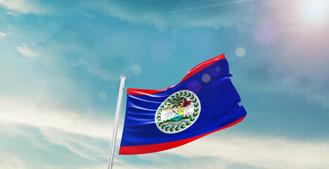 Belize national flag waving with beautiful sky. 