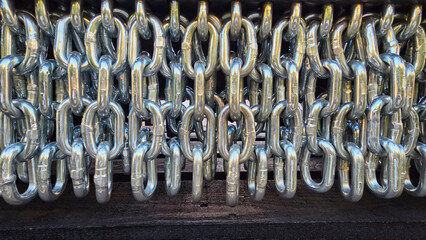 A row of intertwined shiny metal chains