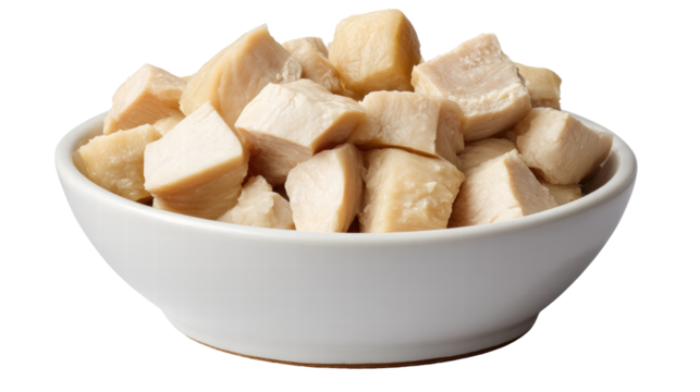 Cooked chicken breast pieces isolated on transparent background in white bowl