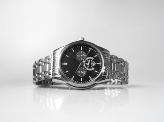 silver steel watch with black dial isolated on white background