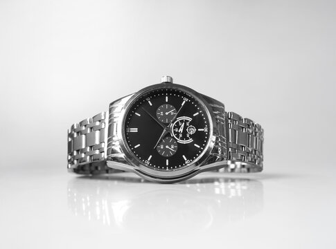 silver steel watch with black dial isolated on white background