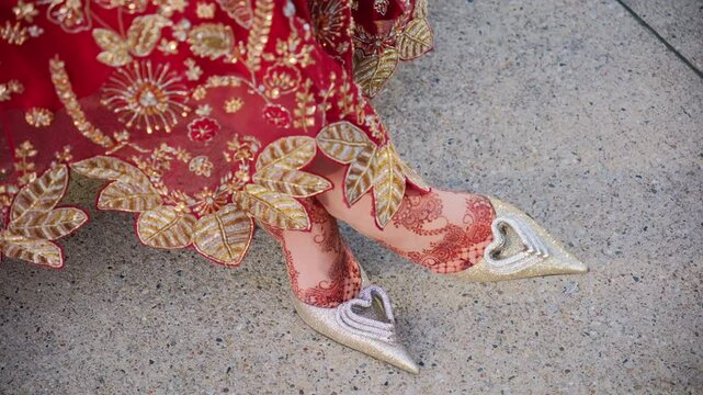 Traditional henna painting on legs and Red color traditional Indian clothes, Elements of hindu wedding. 