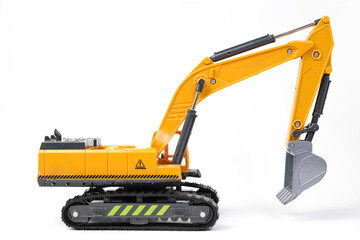 A miniature model of a yellow excavator on isolated on white background. Highlighting construction equipment. Yellow excavator model toy
