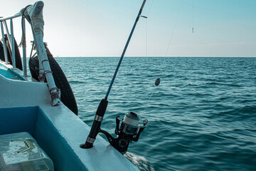 Fishing rod and reel on a boat ready for sea fishing on a sunny day