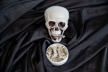 Skull Chewing Tobacco on Black Cloth. 