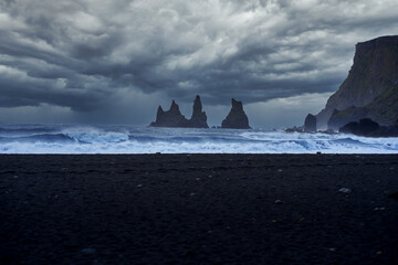 Rock pillars in the crazy sea at the Vik black sand beach, Iceland , Travel destination roadtrip in Iceland .