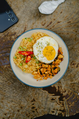Fried rice is a dish of rice that is fried and mixed with cooking oil, margarine, or butter, and various ingredients and spices.