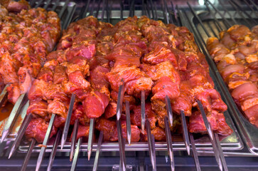 A rack of meat with skewers on it