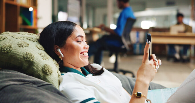 Phone, woman and student relaxing in library with networking, connectivity or contact on mobile app. Earphones, bean bag and person with cellphone for texting with communication online on campus.