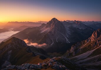 Majestic Mountain Peak Bathed in Golden Light at Dawn with Foggy Valley