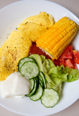 Healthy nutritious breakfast plate with omelette, mixed vegetable and yoghut in the morning