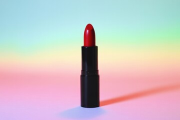 Fototapeta premium Single Red Lipstick Black Tube Pastel Background black lipstick tube