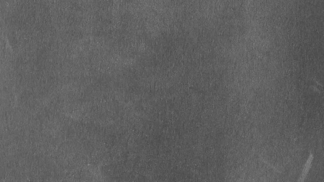 Stop motion background video. Black old paper texture background with dust and scratches. Background and copy space for text and images. Looping video.