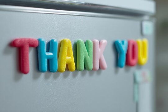 Colorful fridge magnets spell gratitude magic on cool metallic canvas, perfect for Random Acts of Kindness Day vibes