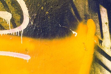 Abstract street art with bold yellow, white brush strokes on textured wall. Graffiti style, urban...