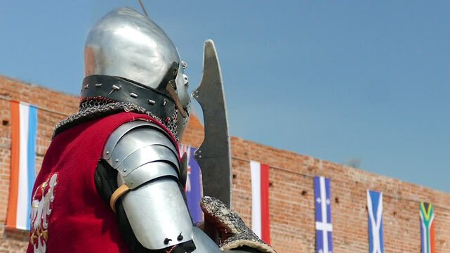 Medieval knight and the walls of the castle. Slow motion