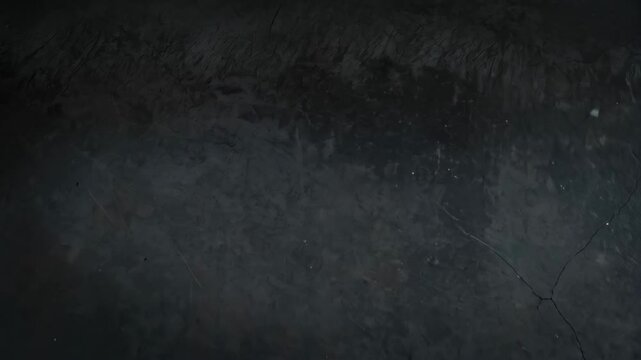 Elegant dark gray concrete wall with cracks and textured patterns, subtle light reflections creating a somber and sophisticated background