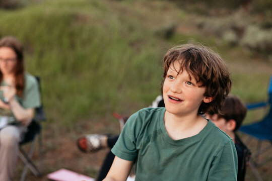 Curious boy listening attentively during camping trip with family