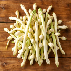 White fresh asparagus sprouts on wooden table. Royal vegetable. Top view.