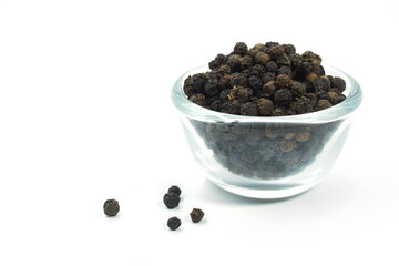 Pepper seeds in a cup placed on a white background.