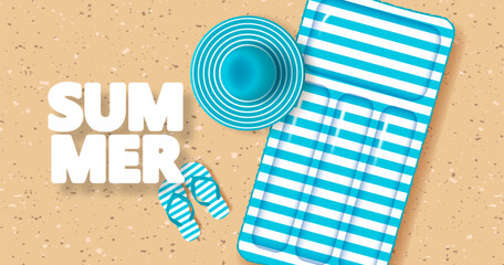 Beach hat, striped flip-flop sandals and inflatable mattress on sandy beach